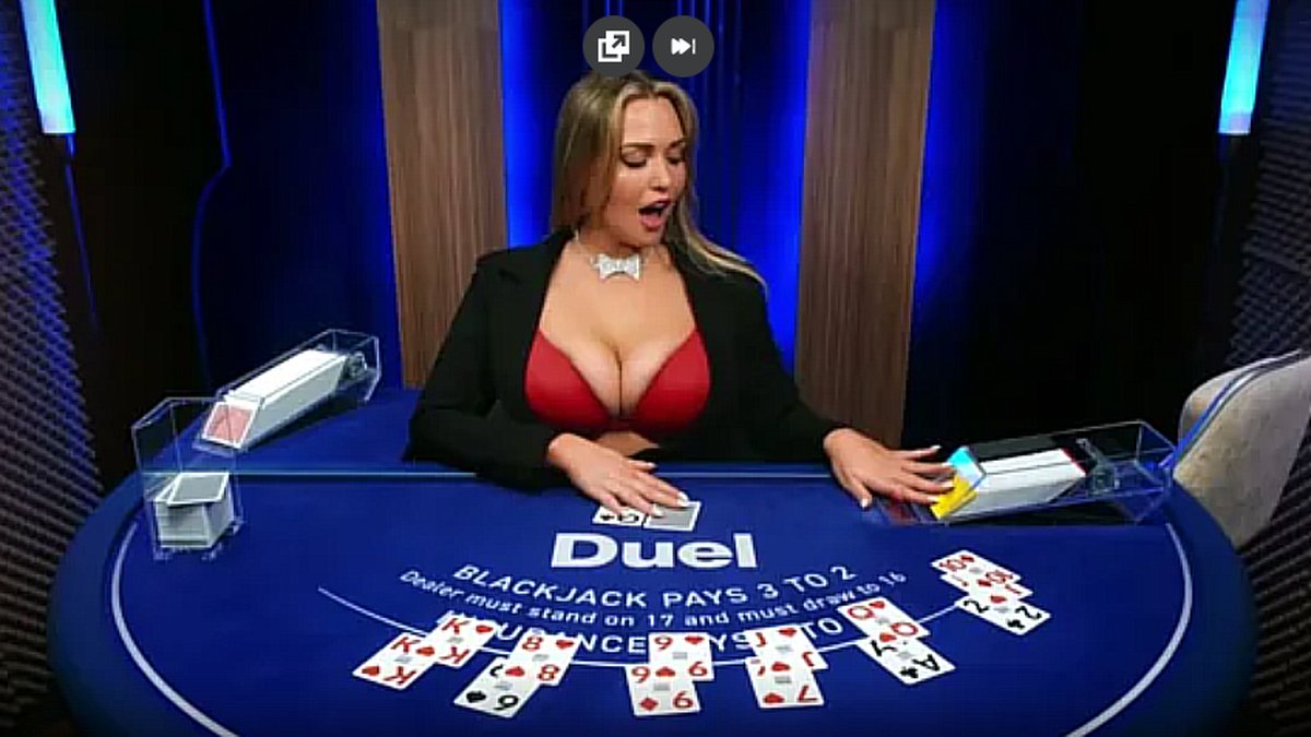 Mia Malkova as live blackjack dealer at Duel Casino blue table